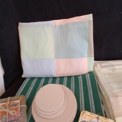 Table linens, placemats, kitchen towels, and corked back hot plate pads
