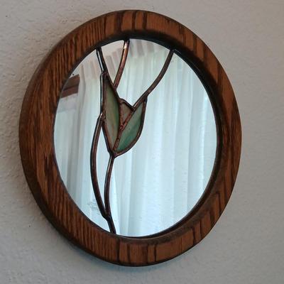 Two oak framed stained glass like wall mirrors