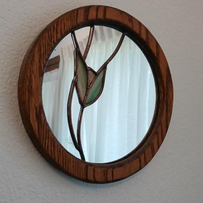 Two oak framed stained glass like wall mirrors