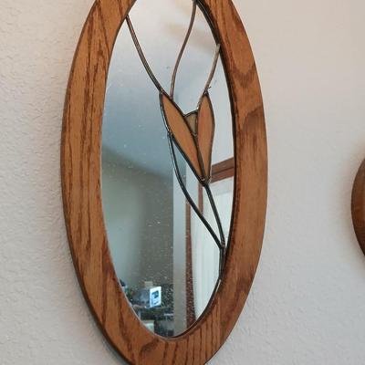Two oak framed stained glass like wall mirrors