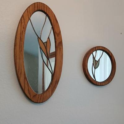 Two oak framed stained glass like wall mirrors
