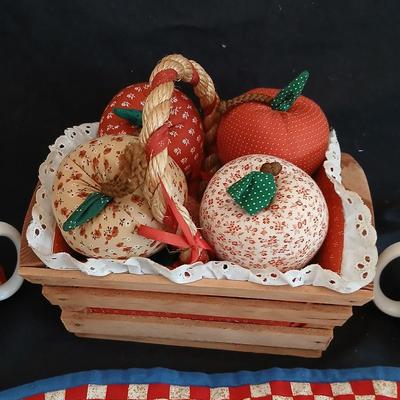 Two Garden Bloom placemats with fabric handmade apples in a basket, and mugs with a spoon rest