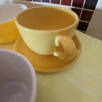 Kitchen items - placemats, small Pyrex mixing bowl, mug, napkins, kitchen towels, and more