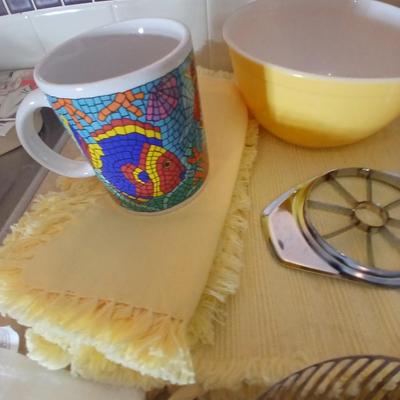 Kitchen items - placemats, small Pyrex mixing bowl, mug, napkins, kitchen towels, and more