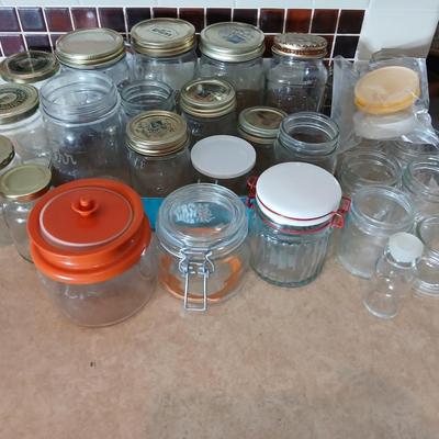 Glass jars of all sizes and shapes - some with lids - some without.