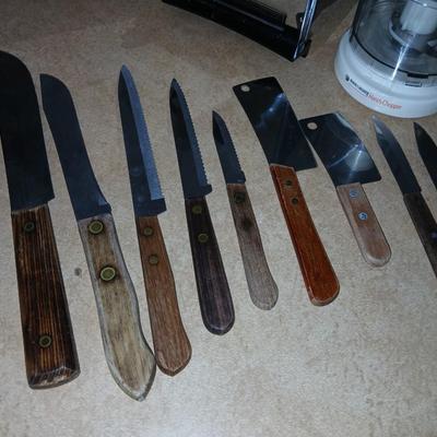 Chrome colored toaster with small electric chopper and wood handled knives