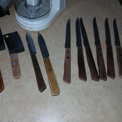 Chrome colored toaster with small electric chopper and wood handled knives