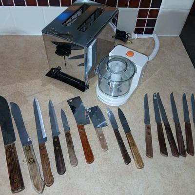 Chrome colored toaster with small electric chopper and wood handled knives