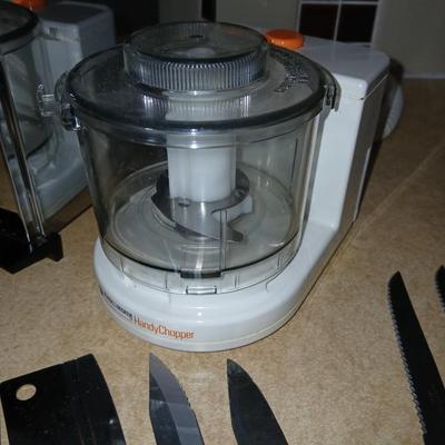 Chrome colored toaster with small electric chopper and wood handled knives