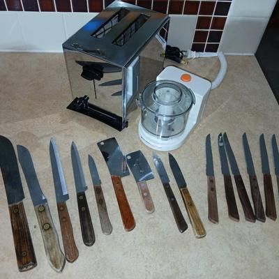 Chrome colored toaster with small electric chopper and wood handled knives