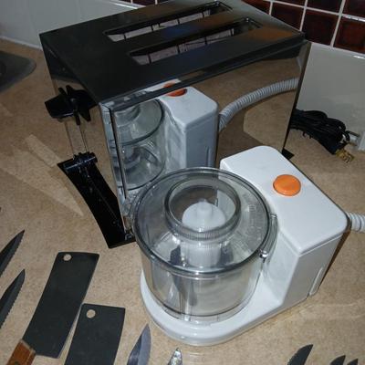 Chrome colored toaster with small electric chopper and wood handled knives