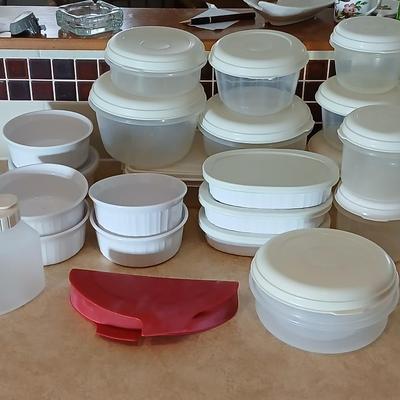 Plastic food storage containers with a few corning ware bowls