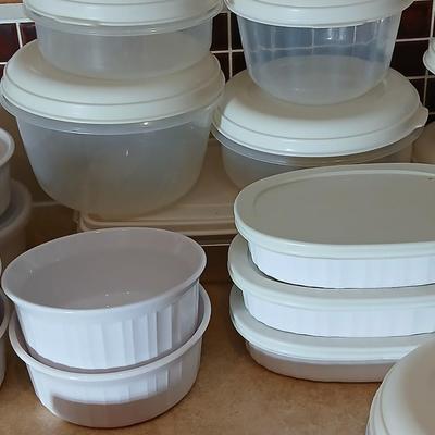 Plastic food storage containers with a few corning ware bowls
