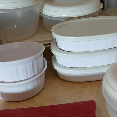 Plastic food storage containers with a few corning ware bowls