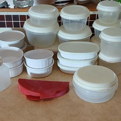 Plastic food storage containers with a few corning ware bowls