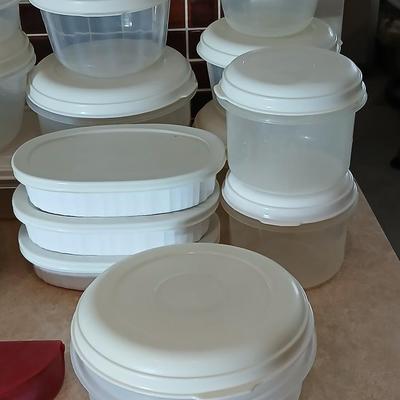 Plastic food storage containers with a few corning ware bowls