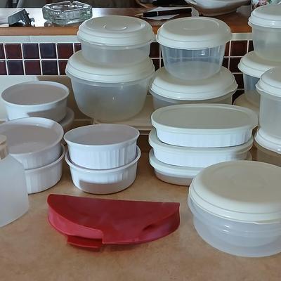 Plastic food storage containers with a few corning ware bowls