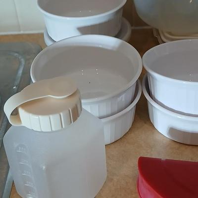 Plastic food storage containers with a few corning ware bowls