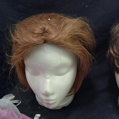 Two Styrofoam heads with wigs and two Turbie hair towels