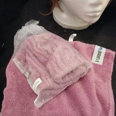 Two Styrofoam heads with wigs and two Turbie hair towels