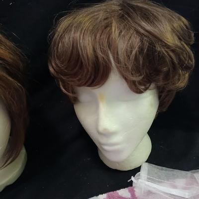 Two Styrofoam heads with wigs and two Turbie hair towels