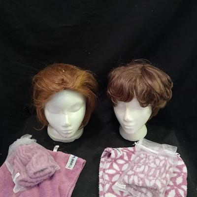Two Styrofoam heads with wigs and two Turbie hair towels