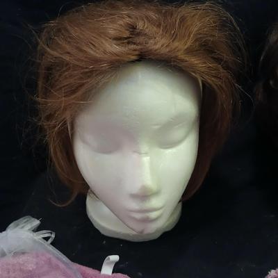 Two Styrofoam heads with wigs and two Turbie hair towels