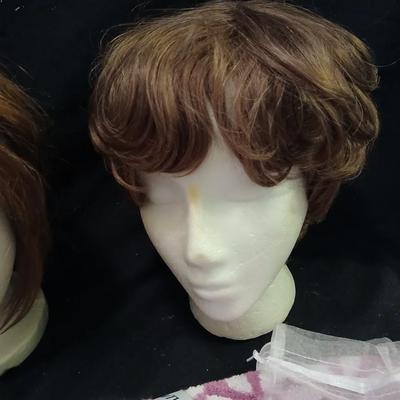 Two Styrofoam heads with wigs and two Turbie hair towels