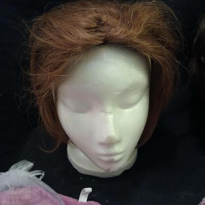 Two Styrofoam heads with wigs and two Turbie hair towels