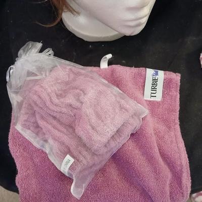 Two Styrofoam heads with wigs and two Turbie hair towels