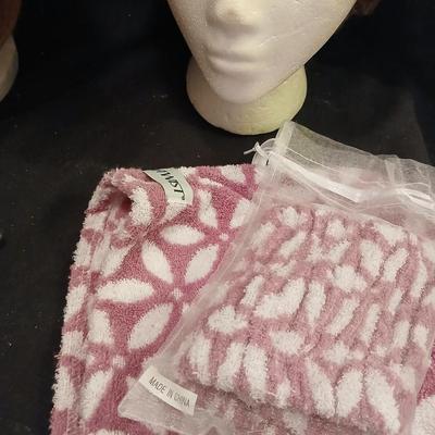 Two Styrofoam heads with wigs and two Turbie hair towels