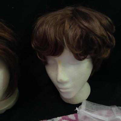 Two Styrofoam heads with wigs and two Turbie hair towels