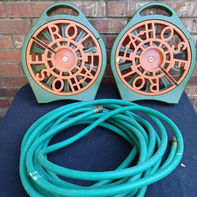 Two hose reels and a garden hose