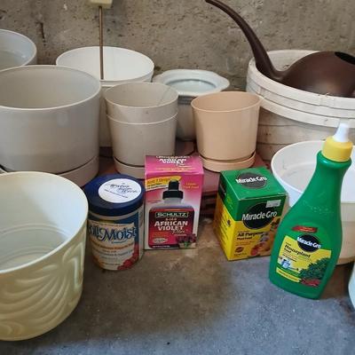 Assortment of plastic flowerpots with some plant food and more