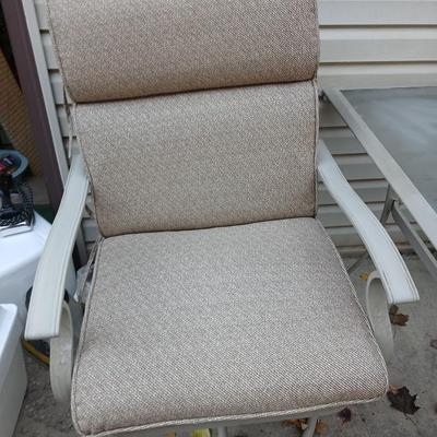 Two patio chairs and cushions with small glass topped patio table