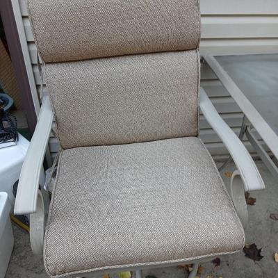 Two patio chairs and cushions with small glass topped patio table