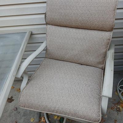Two patio chairs and cushions with small glass topped patio table
