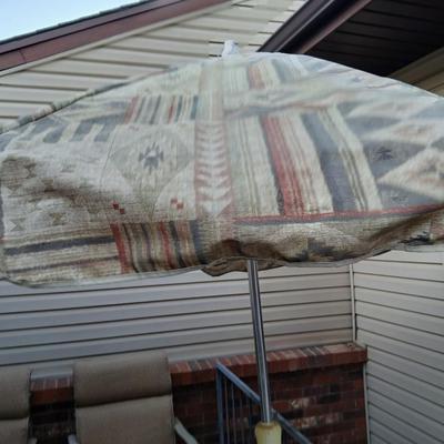 Southwestern print Patio umbrella with holder and small glass topped table