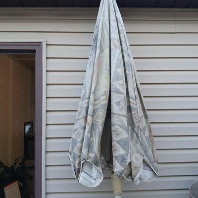 Southwestern print Patio umbrella with holder and small glass topped table