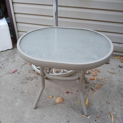 Southwestern print Patio umbrella with holder and small glass topped table