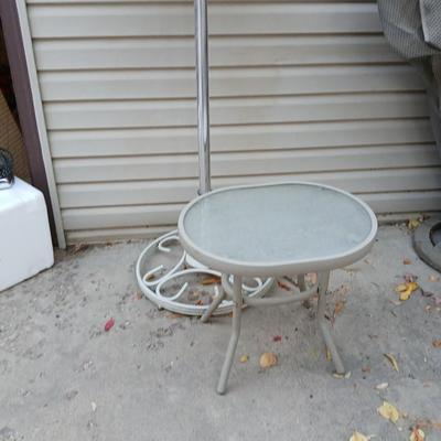 Southwestern print Patio umbrella with holder and small glass topped table