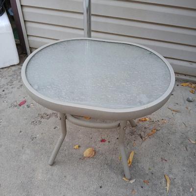 Southwestern print Patio umbrella with holder and small glass topped table