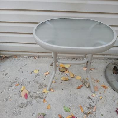Brown Umbrella with stand and a small glass topped table
