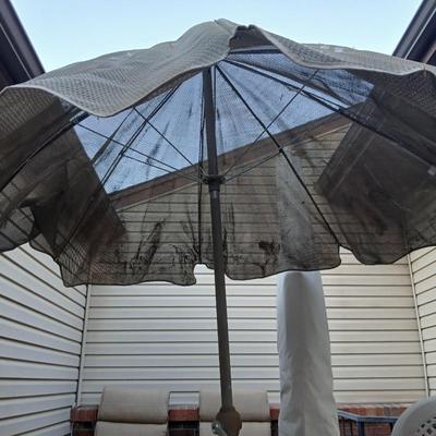 Brown Umbrella with stand and a small glass topped table