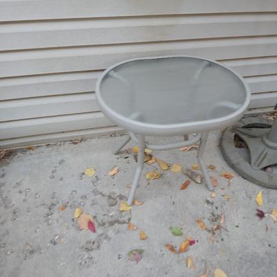 Brown Umbrella with stand and a small glass topped table