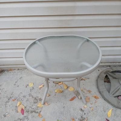 Brown Umbrella with stand and a small glass topped table