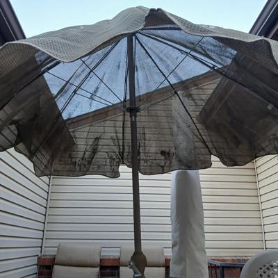Brown Umbrella with stand and a small glass topped table