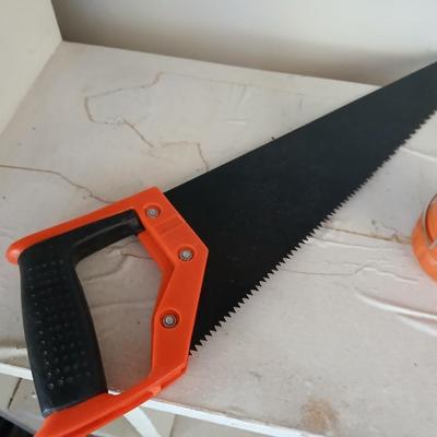 Grouping of orange tools, saws, level, strap wrench, flashlight, and more