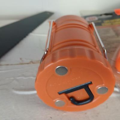 Grouping of orange tools, saws, level, strap wrench, flashlight, and more