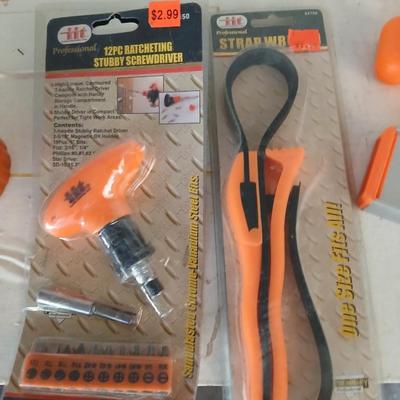 Grouping of orange tools, saws, level, strap wrench, flashlight, and more